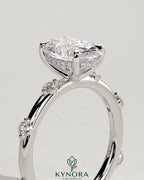Kynora CJ 2ct oval claw solitaire engagement ring with six round accent stones and hidden halo, crafted in elegant jewelry design.