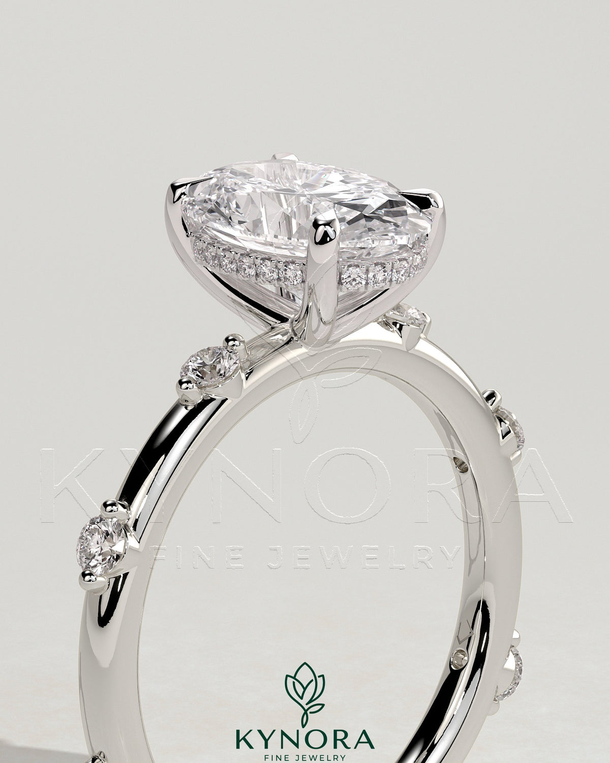 Kynora CJ 2ct oval claw solitaire engagement ring with six round accent stones and hidden halo, crafted in elegant jewelry design.