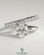 Kynora CJ 2ct oval claw solitaire engagement ring with angled pave band, featuring a sparkling oval diamond and intricate band design.