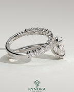 Kynora CJ 2ct oval claw solitaire engagement ring with angled pave band, showcasing a sparkling oval diamond and detailed band design.