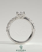 Kynora CJ 2ct oval claw solitaire engagement ring with angled pave band, showcasing a sparkling oval diamond on a sleek band.