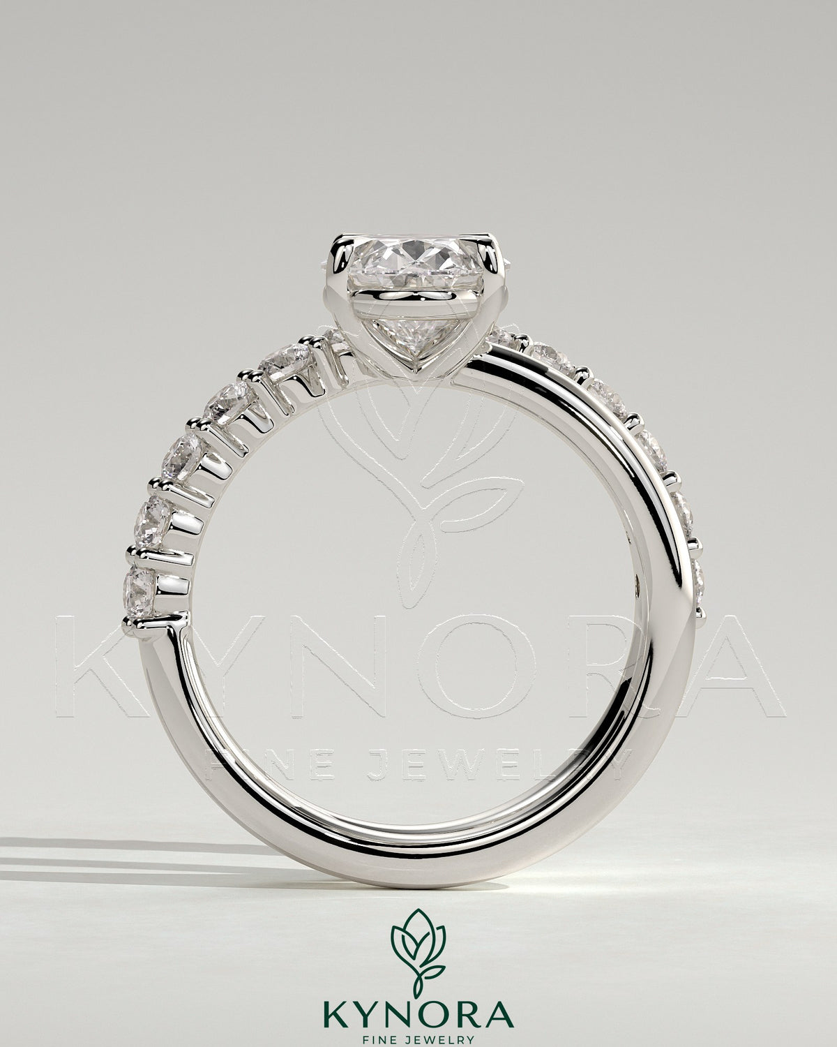 Kynora CJ 2ct oval claw solitaire engagement ring with angled pave band, showcasing a sparkling oval diamond on a sleek band.