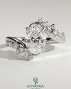 Kynora CJ 2ct oval claw solitaire engagement ring with bypass band and clustered round-marquise accent stones.