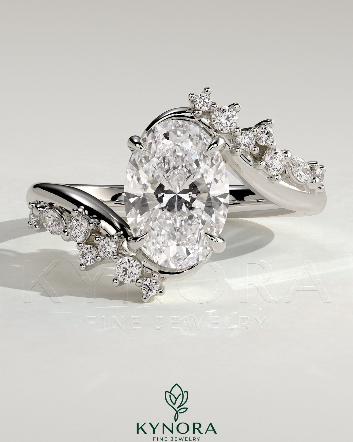 Kynora CJ 2ct oval claw solitaire engagement ring with bypass band and clustered round-marquise accent stones.