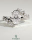 Kynora CJ 2ct oval claw solitaire engagement ring with bypass band and clustered round-marquise accent stones.