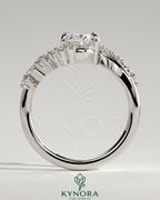 Kynora CJ 2ct oval claw solitaire engagement ring with bypass band and clustered round-marquise accent stones.