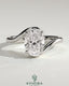 Kynora CJ 2ct oval claw solitaire engagement ring with bypass band, showcasing a sparkling oval diamond and sleek gold setting