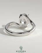 Kynora CJ 2ct oval claw solitaire engagement ring with bypass band, featuring a sparkling center stone and intricate band design.