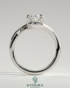 Kynora CJ 2-carat oval claw solitaire engagement ring with bypass band showcasing a sparkling center stone and intricate band design.