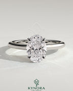 Kynora CJ 2ct oval claw solitaire engagement ring with cathedral high setting and intricate band design.
