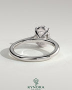 Kynora CJ 2ct oval claw solitaire engagement ring with cathedral high setting, showcasing a sparkling center diamond and elegant band.