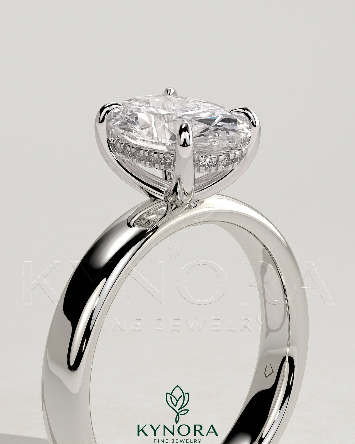 Kynora CJ 2ct oval claw solitaire engagement ring with cigar band and hidden halo, featuring a sparkling center gemstone.