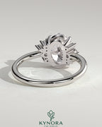 Kynora CJ 2ct oval claw solitaire engagement ring with clustered round shoulder stones, elegant and sparkling jewelry piece