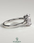 Kynora CJ 2ct oval claw solitaire engagement ring with clustered round shoulder stones, elegant and sparkling jewelry piece