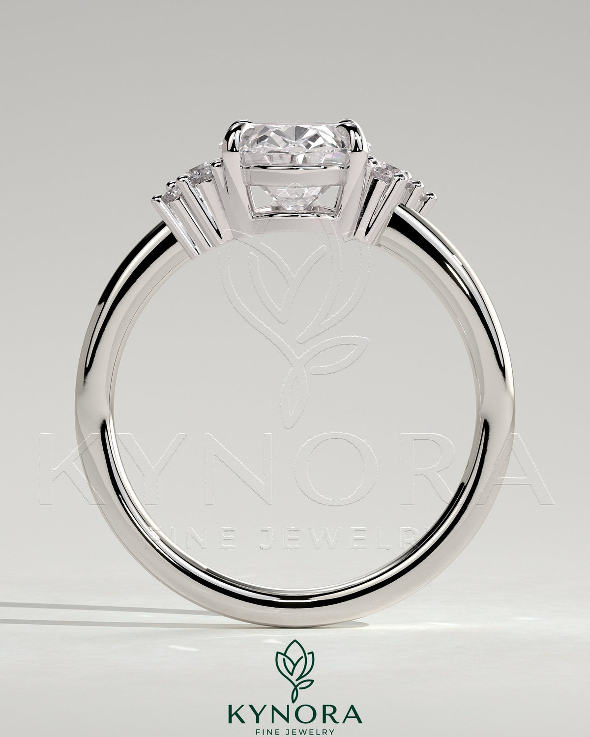 Kynora CJ 2ct oval claw solitaire engagement ring with clustered round shoulder stones, elegant and sparkling jewelry piece.