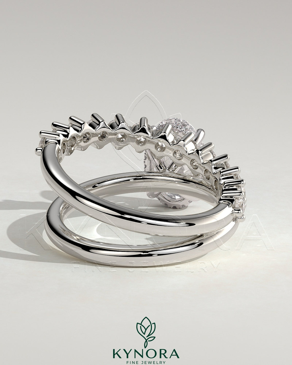 Kynora CJ 2ct oval claw solitaire engagement ring with double band featuring plain and round accent stones.