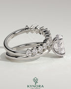 Kynora CJ 2ct oval claw solitaire engagement ring with double plain and round accent stones on band, elegant jewelry design