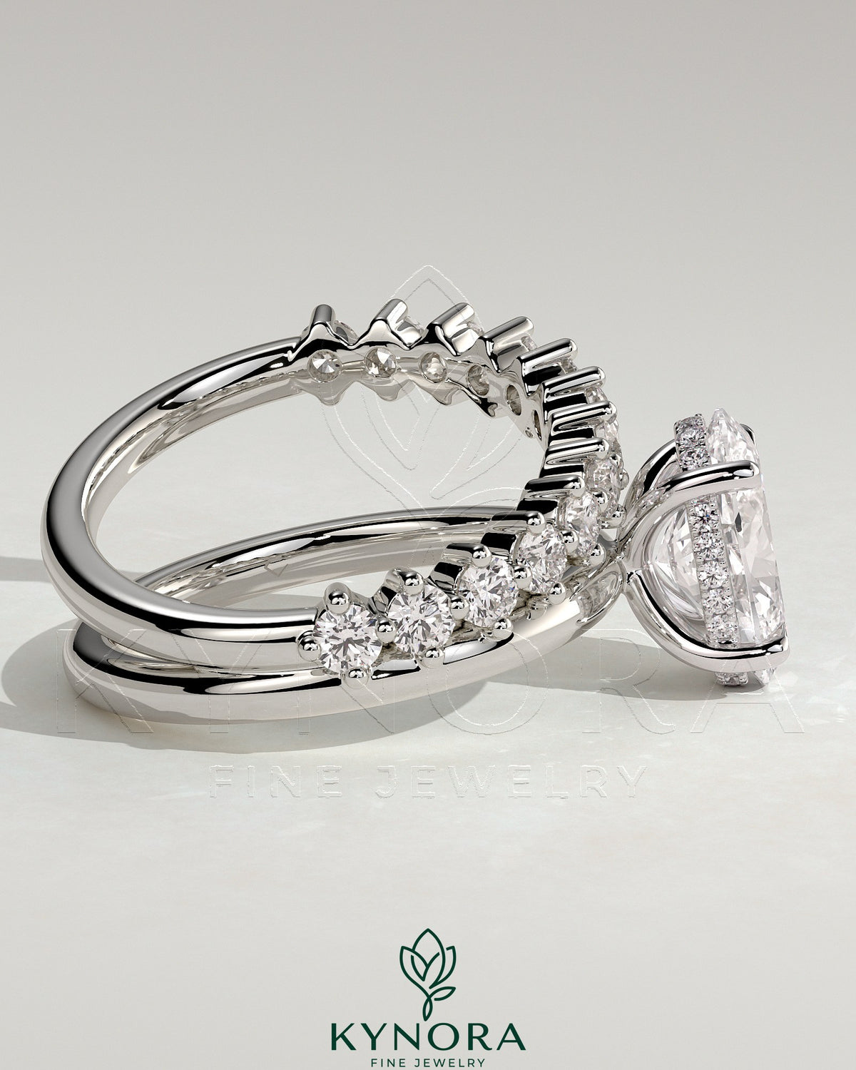 Kynora CJ 2ct oval claw solitaire engagement ring with double plain and round accent stones on band, elegant jewelry design