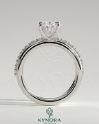 Kynora CJ 2ct oval claw solitaire engagement ring with double band and round accent stones, elegant and sparkling jewelry piece.