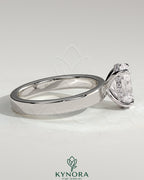 Kynora CJ 2ct oval claw solitaire engagement ring with flat cigar band and hidden halo, showcasing elegant diamond setting.