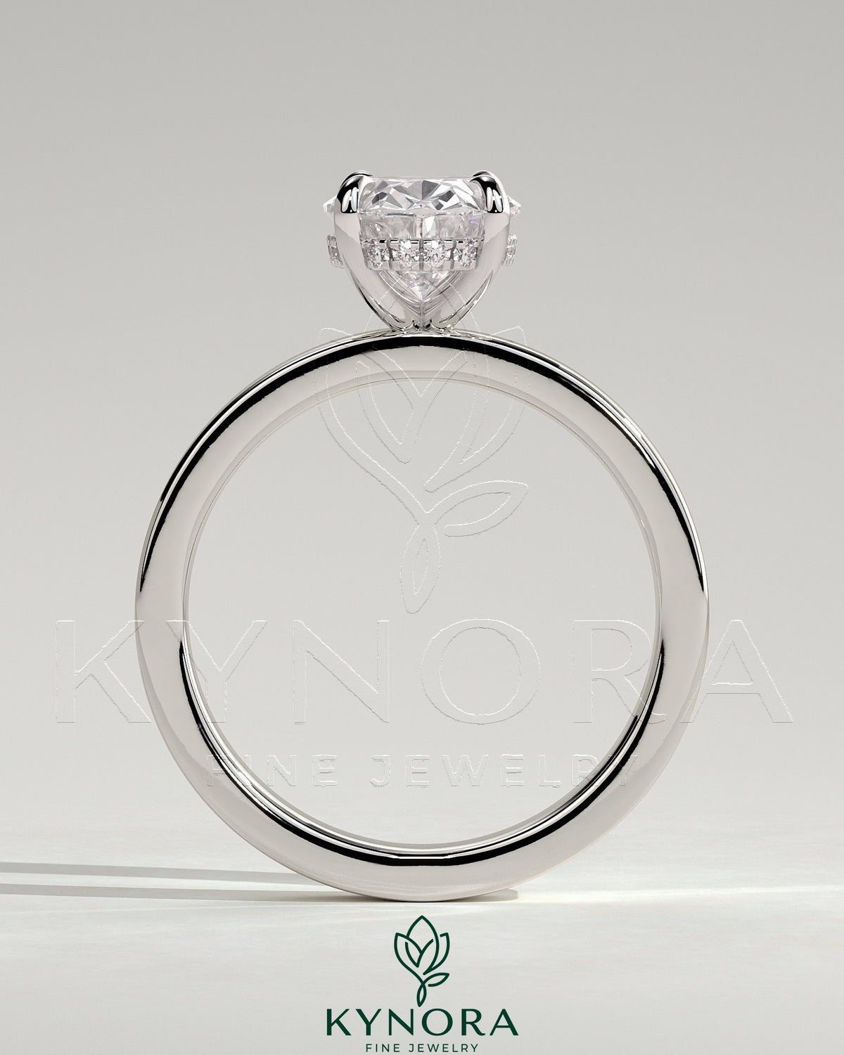 Kynora CJ 2ct oval claw solitaire engagement ring with flat cigar band and hidden halo, showcasing elegant diamond setting.
