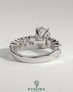 Kynora CJ 2ct oval claw solitaire engagement ring with half eternity band and hidden halo, showcasing detailed craftsmanship.