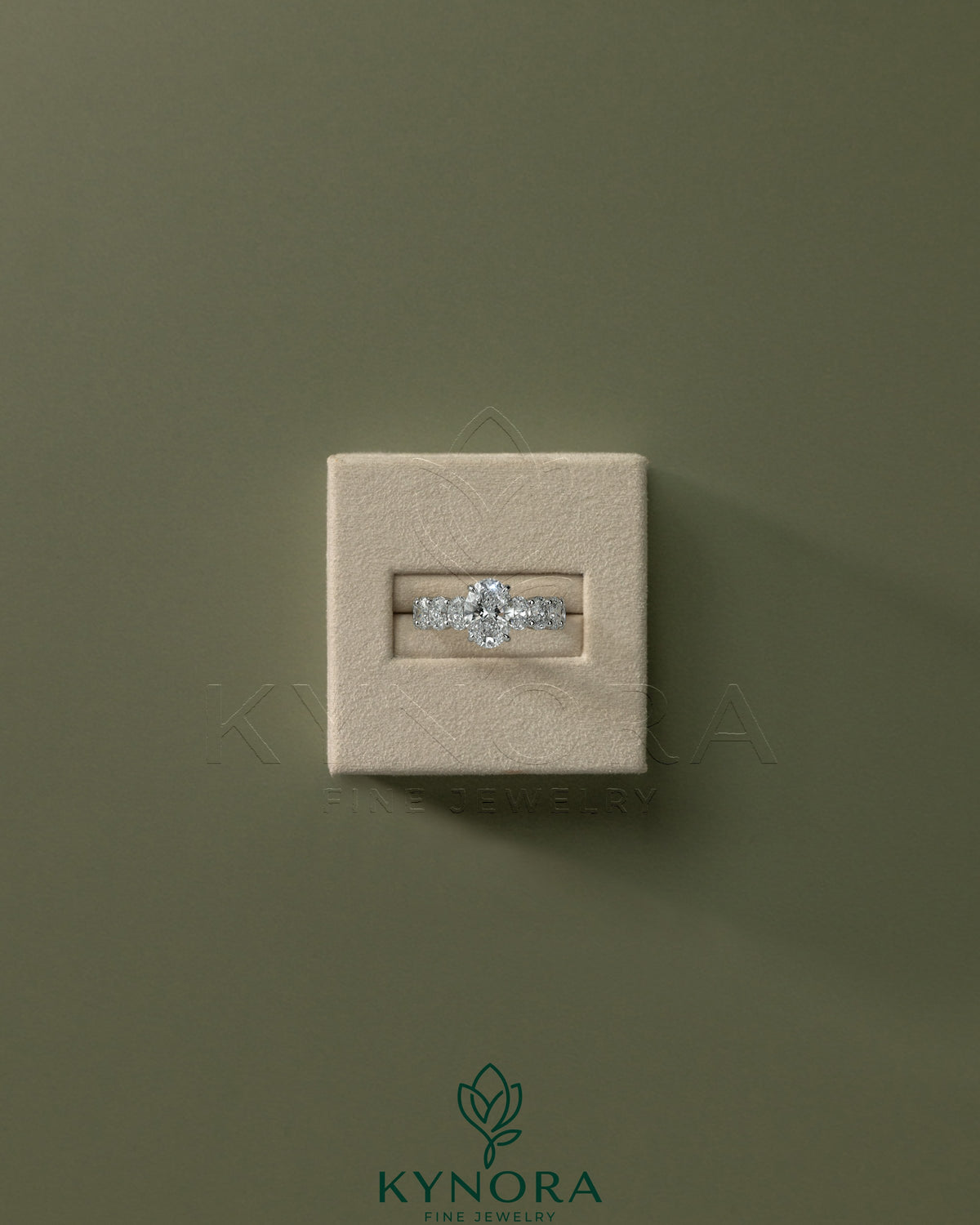 Kynora CJ 2ct oval claw solitaire engagement ring with half eternity oval band and hidden halo design, showcasing sparkling diamond details.
