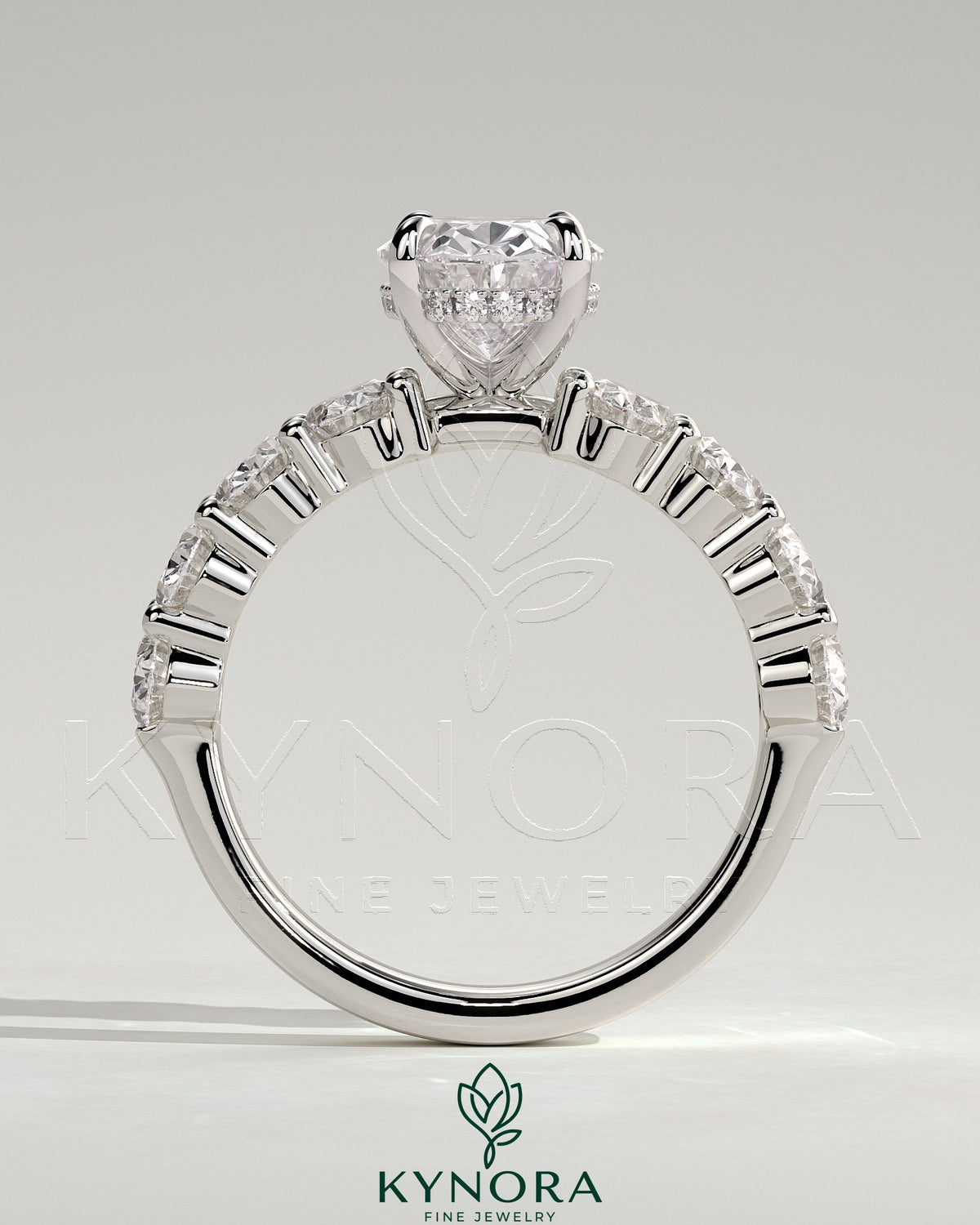 Kynora CJ 2ct oval claw solitaire engagement ring with half eternity oval band and hidden halo, showcasing sparkling diamond details.