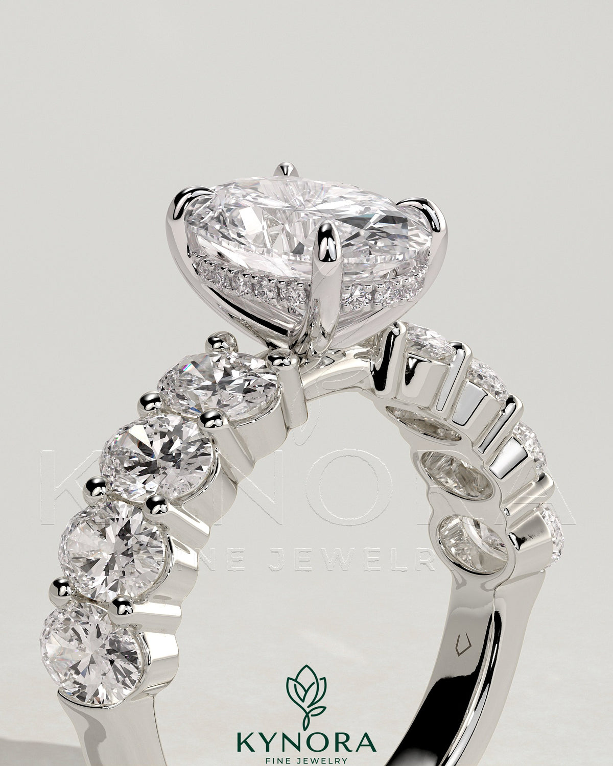 Kynora CJ 2ct oval claw solitaire engagement ring with half eternity oval band and hidden halo design.