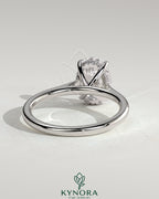 Kynora CJ 2ct oval claw solitaire engagement ring with hidden halo and cathedral high setting, showcasing intricate design and sparkling diamond