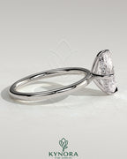 Kynora CJ 2ct oval claw solitaire engagement ring with hidden halo and compass rotation design, featuring sparkling diamond accents.