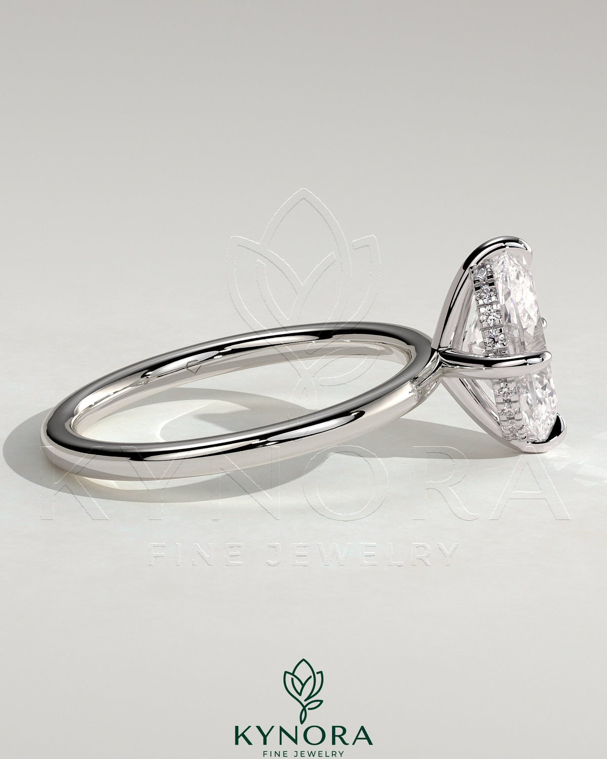 Kynora CJ 2ct oval claw solitaire engagement ring with hidden halo and compass rotation design, featuring sparkling diamond accents.