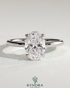 Kynora CJ 2ct oval claw solitaire engagement ring with hidden halo and floating cathedral low setting, showcasing elegant jewelry design.