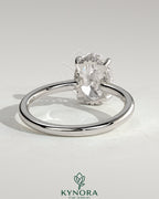 Kynora CJ 2ct oval claw solitaire engagement ring with hidden halo and floating cathedral low setting, showcasing elegant jewelry craftsmanship.