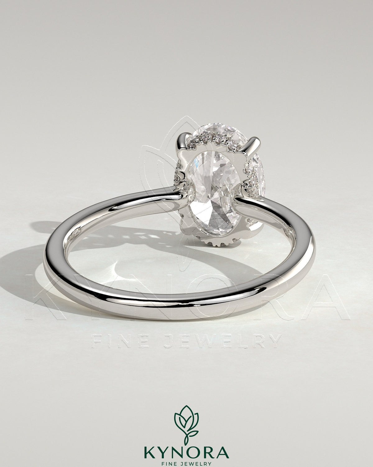 Kynora CJ 2ct oval claw solitaire engagement ring with hidden halo and floating cathedral low setting, showcasing elegant jewelry craftsmanship.