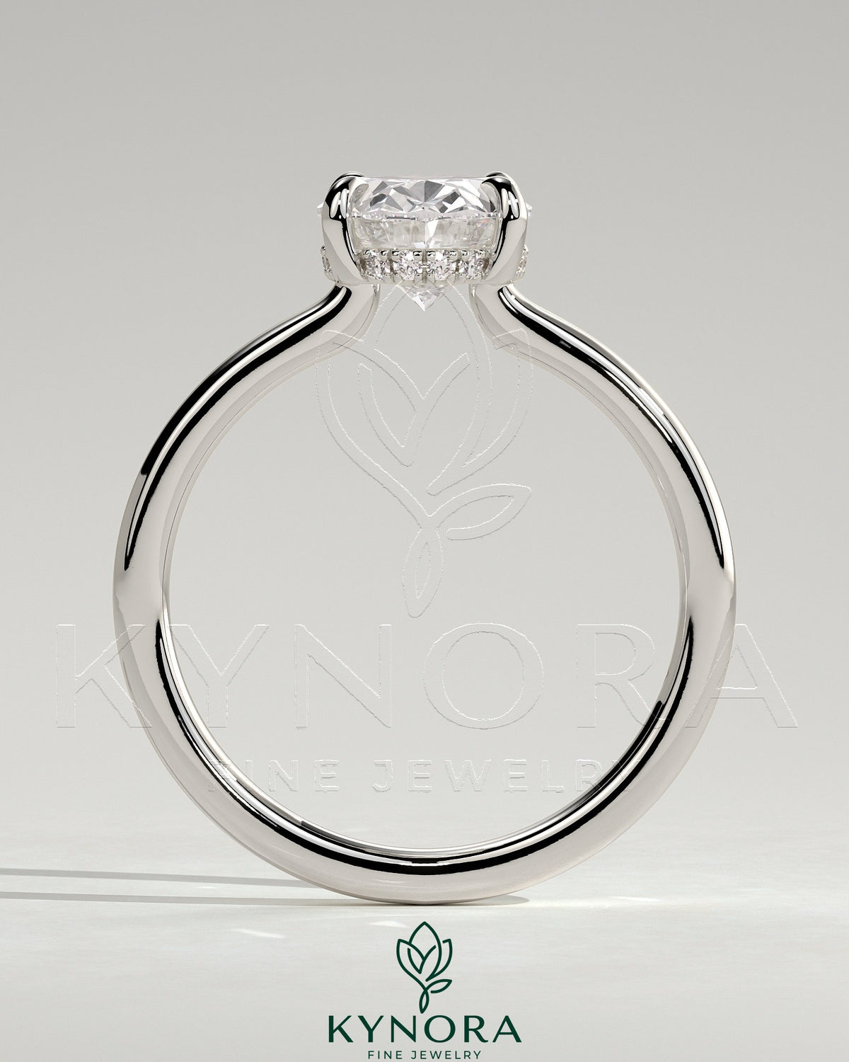 Kynora CJ 2ct oval claw solitaire engagement ring with hidden halo and floating cathedral low setting, showcasing elegant jewelry craftsmanship.