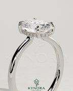 Kynora CJ 2ct oval claw solitaire engagement ring with hidden halo and floating cathedral low setting, showcasing elegant diamond design.