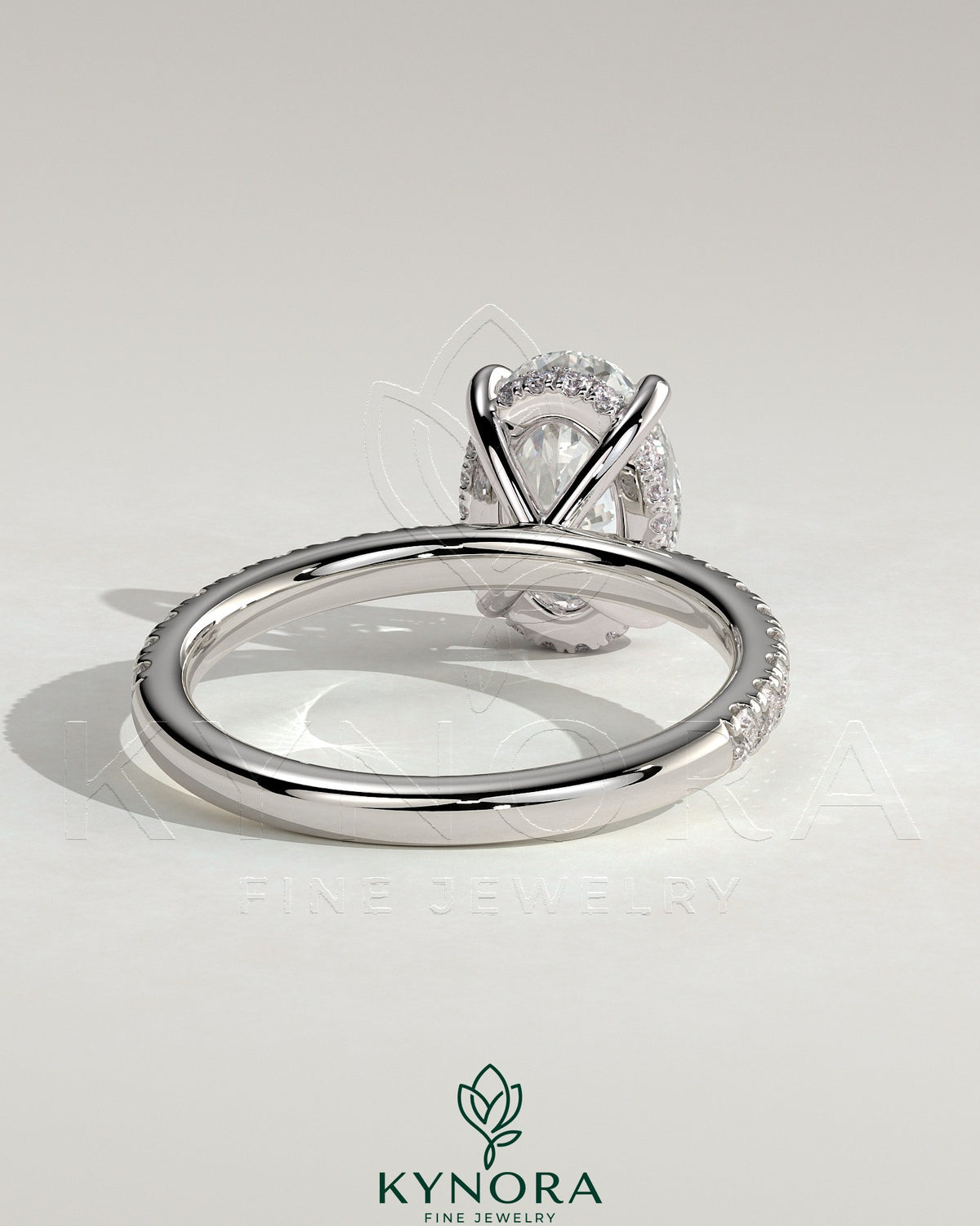 Kynora CJ 2ct oval claw solitaire engagement ring with hidden halo and pave band, showcasing elegant diamond design.