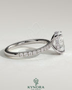 Kynora CJ 2ct oval claw solitaire engagement ring with hidden halo and pave band, showcasing sparkling diamond design.