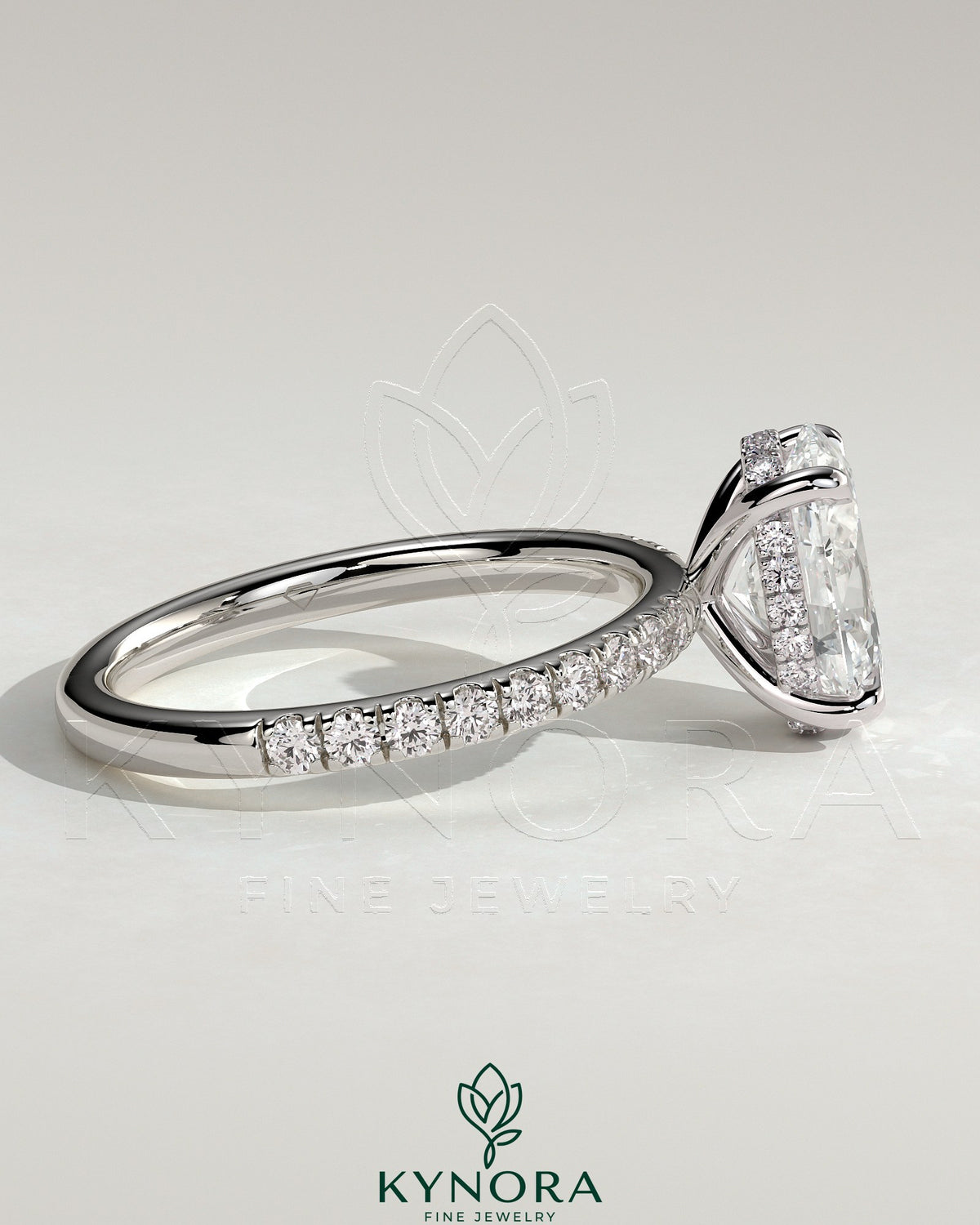 Kynora CJ 2ct oval claw solitaire engagement ring with hidden halo and pave band, showcasing sparkling diamond design.
