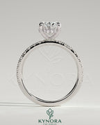 Kynora CJ 2ct oval claw solitaire engagement ring with hidden halo and pave band showcasing sparkling diamond details.
