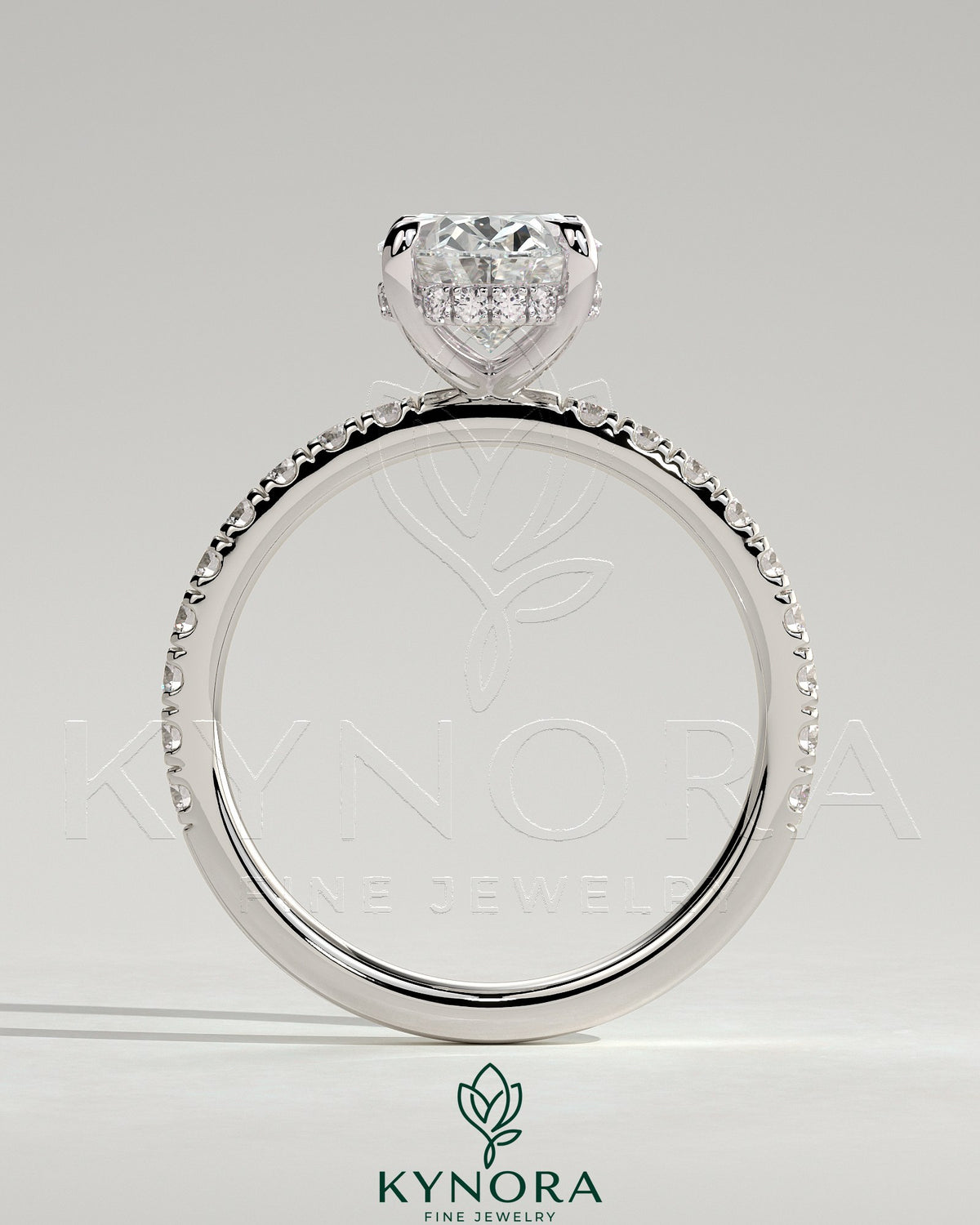 Kynora CJ 2ct oval claw solitaire engagement ring with hidden halo and pave band showcasing sparkling diamond details.