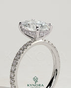 Kynora CJ 2ct oval solitaire engagement ring with hidden halo and pave band, featuring elegant diamond details.