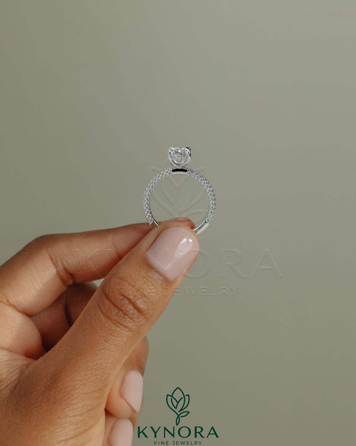 Kynora CJ 2ct oval claw solitaire engagement ring with hidden halo and triple pave band showcasing sparkling diamond details
