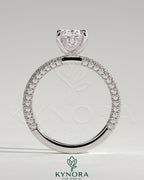 Kynora CJ 2ct oval claw solitaire engagement ring with hidden halo and triple pave band, showcasing intricate diamond setting.