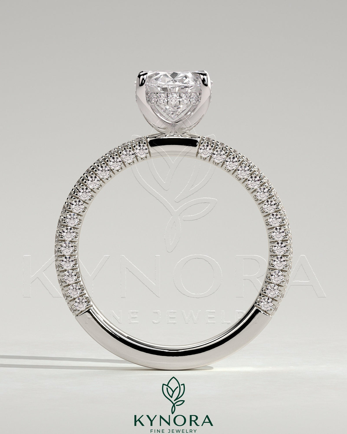 Kynora CJ 2ct oval claw solitaire engagement ring with hidden halo and triple pave band, showcasing intricate diamond setting.