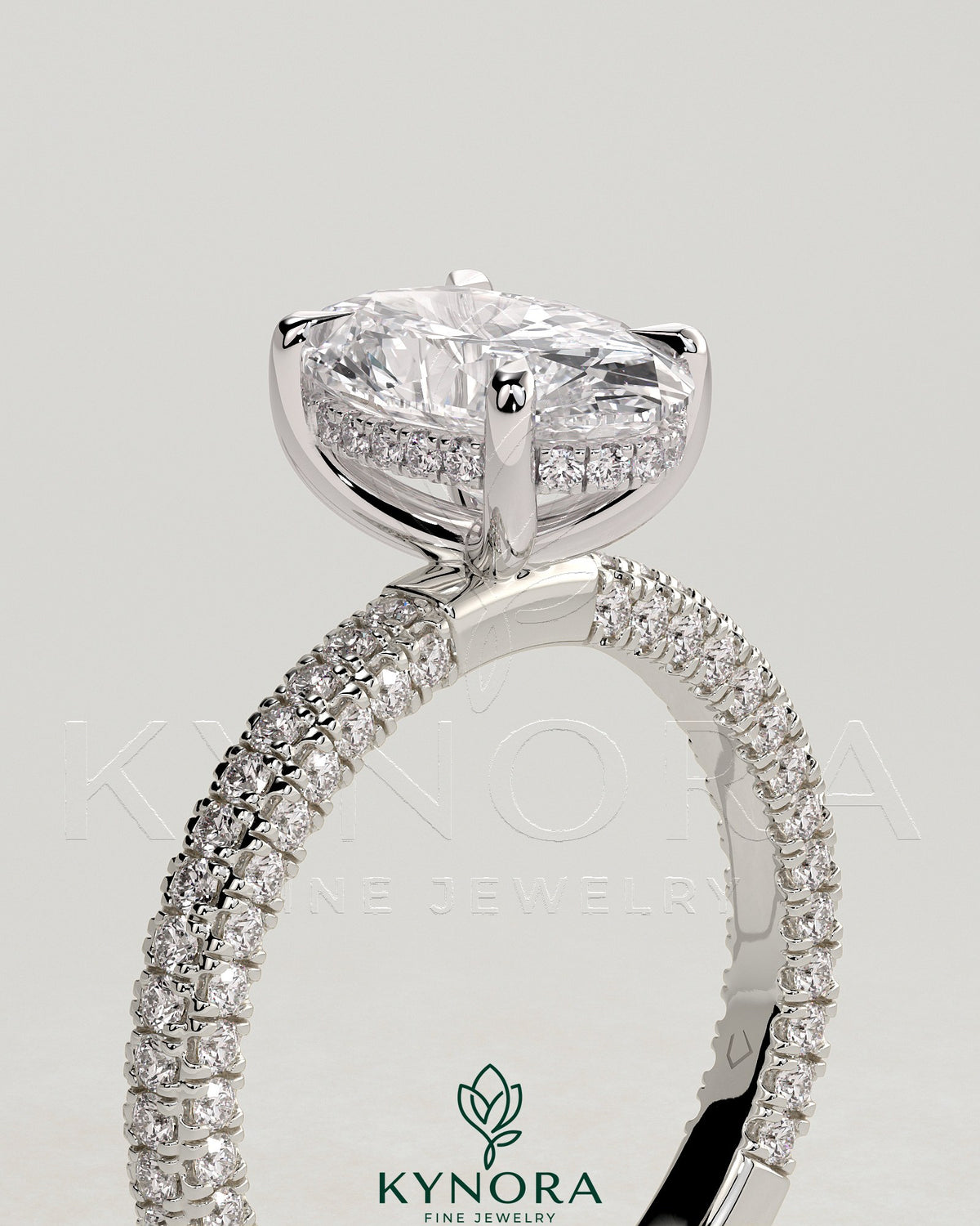 Kynora CJ 2ct oval claw solitaire engagement ring with hidden halo and triple pave band, featuring a sparkling central diamond.