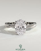 Kynora CJ 2ct oval claw solitaire engagement ring with hidden halo and twisted pave band, showcasing elegant diamond craftsmanship.