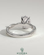 Kynora CJ 2ct oval claw solitaire engagement ring with hidden halo and twisted pave band, showcasing elegant jewelry craftsmanship.
