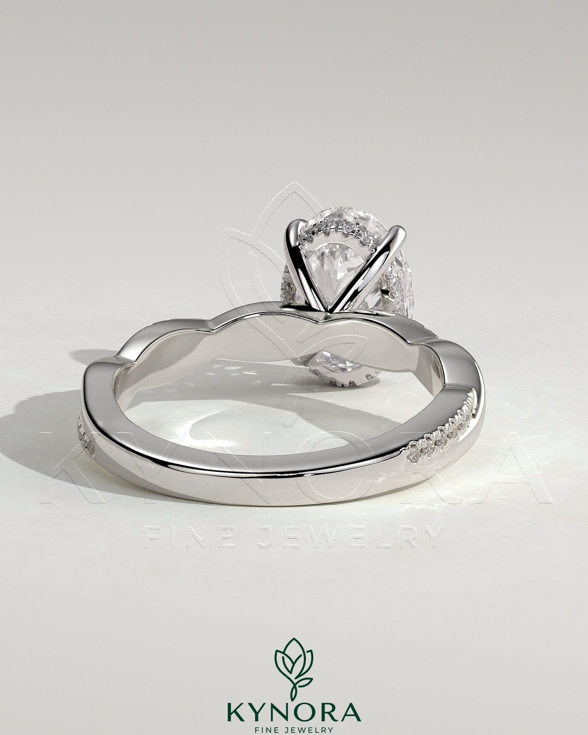 Kynora CJ 2ct oval claw solitaire engagement ring with hidden halo and twisted pave band, showcasing elegant jewelry craftsmanship.